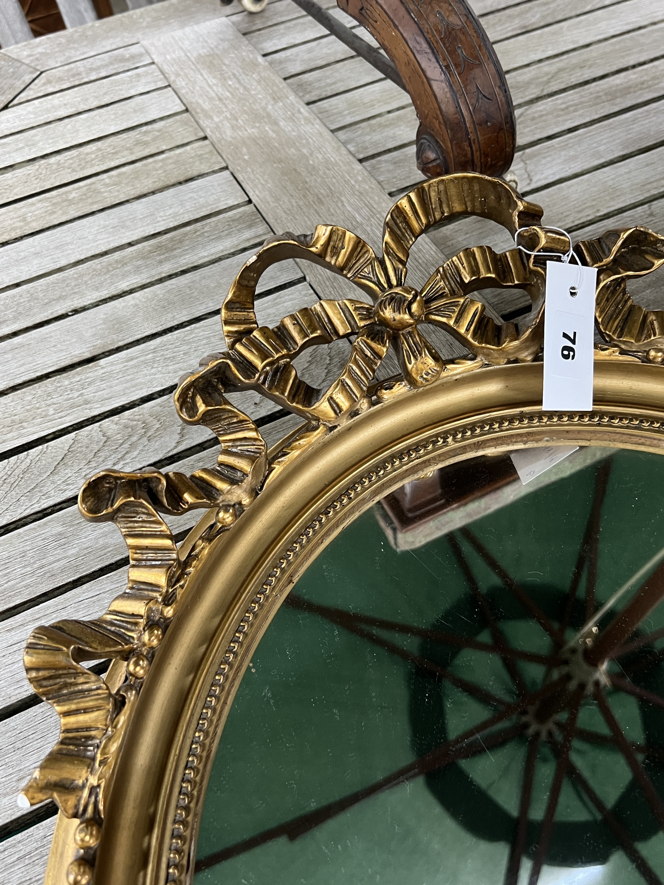 A pair of Victorian style gilt and composition oval mirrors, width 48cm, height 65cm